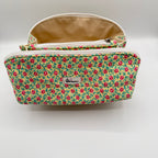 Floral patterned pouch with a visible brand label on a light gray background