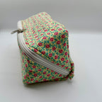 Floral-patterned zippered pouch on a gray background