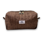 A brown textured canvas cosmetic pouch with a white brand label reading 'Allie Sew Crafty' and two silver zipper pulls, shown on a white background.
