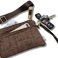 A brown textured fabric crossbody bag with a matching wrist strap, shown with a phone, card, lipstick, keys, and car key fob in its pockets on a white background.