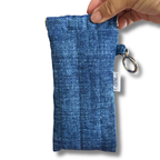 A blue denim-textured sunglasses pouch, on a white background.