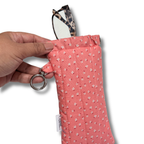 Pink Dainty Daisies quilted Flexi Frame Pouch holding a pair of glasses