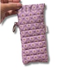 Purple Daisy Bloom quilted Flexi Frame Pouch held in hand, closed, showing the full print