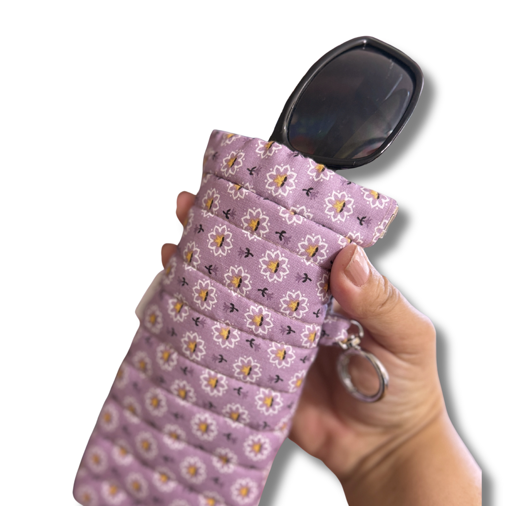 Purple Daisy Bloom quilted Flexi Frame Pouch holding a pair of sunglasses