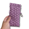 purple pouch with little leaves being held by a hand in a white solid background