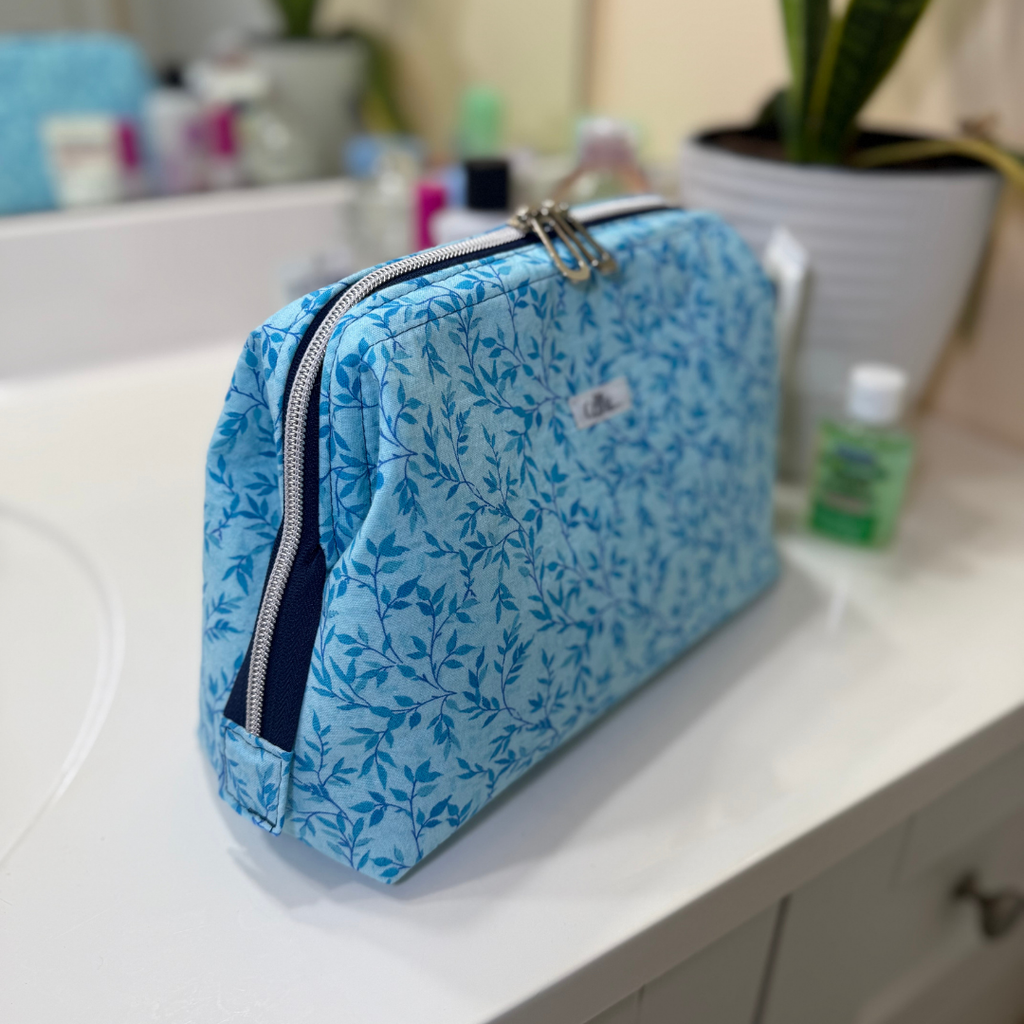 Blue floral-patterned toiletry bag on a bathroom counter
