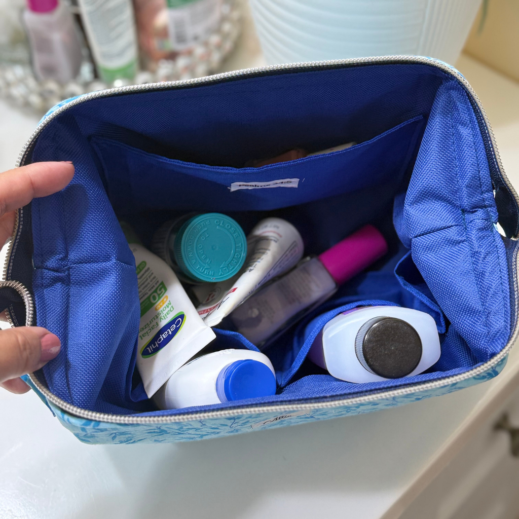 blue pouch open with cosmetics inside