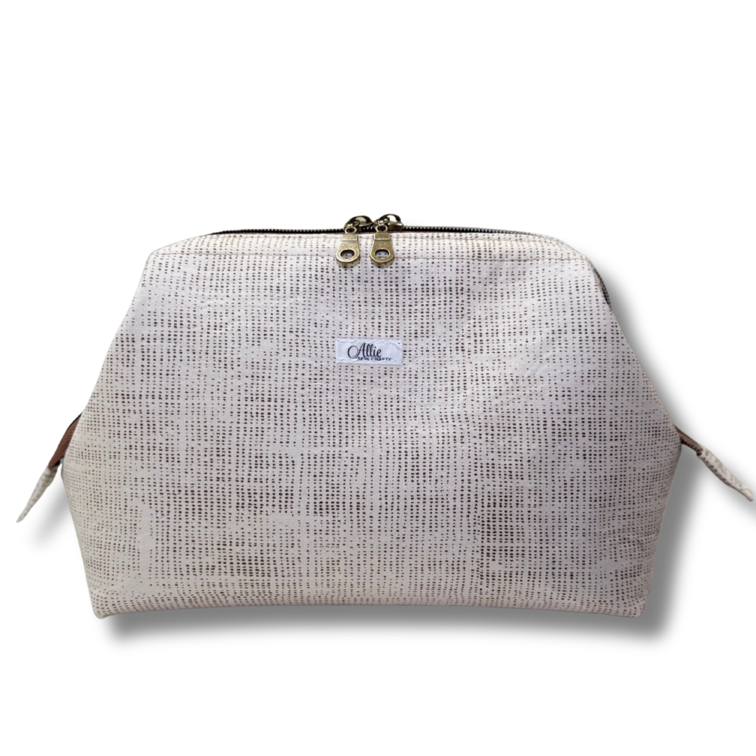 Textured beige pouch with a brand label on a white background