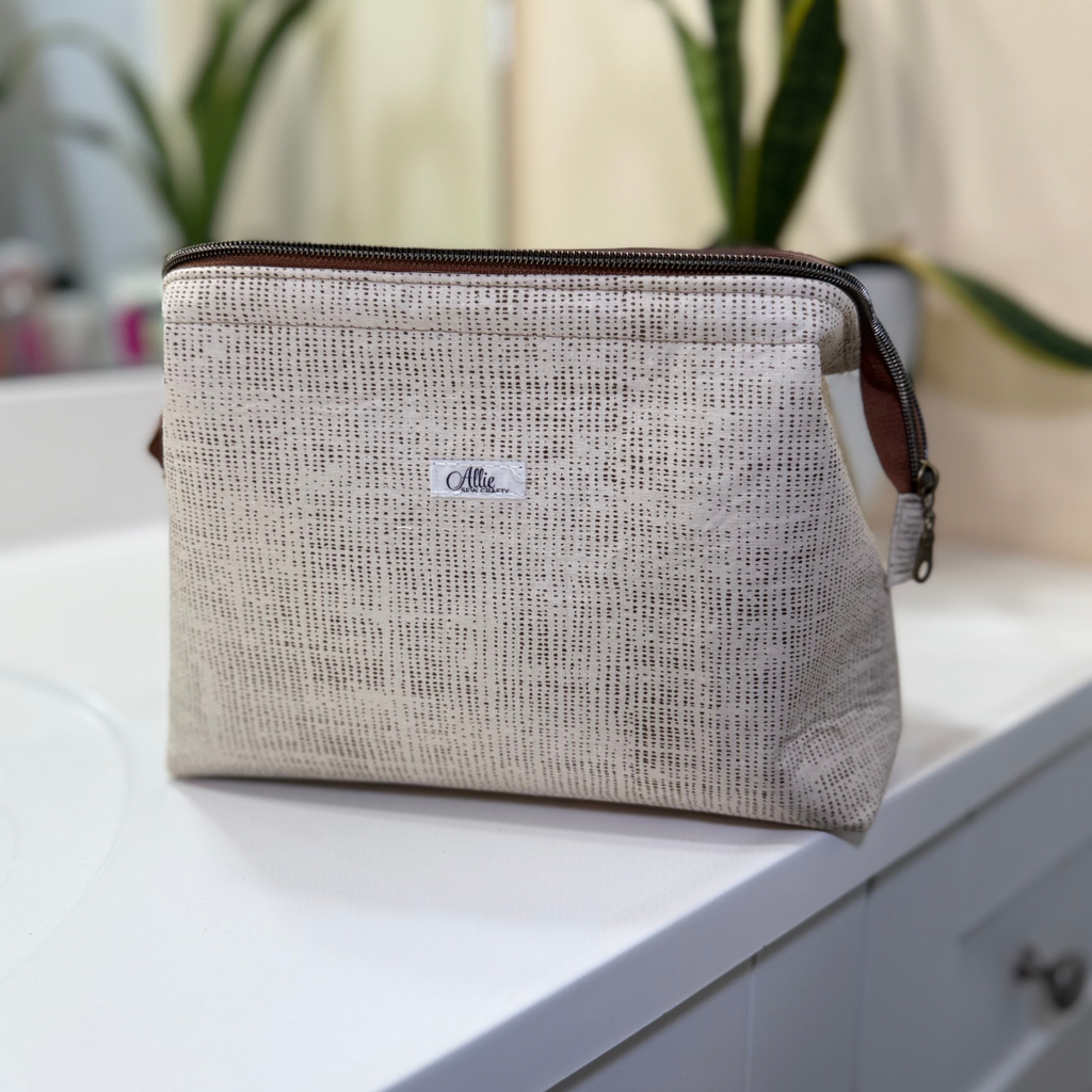 Textured pouch with a brand label on a white surface