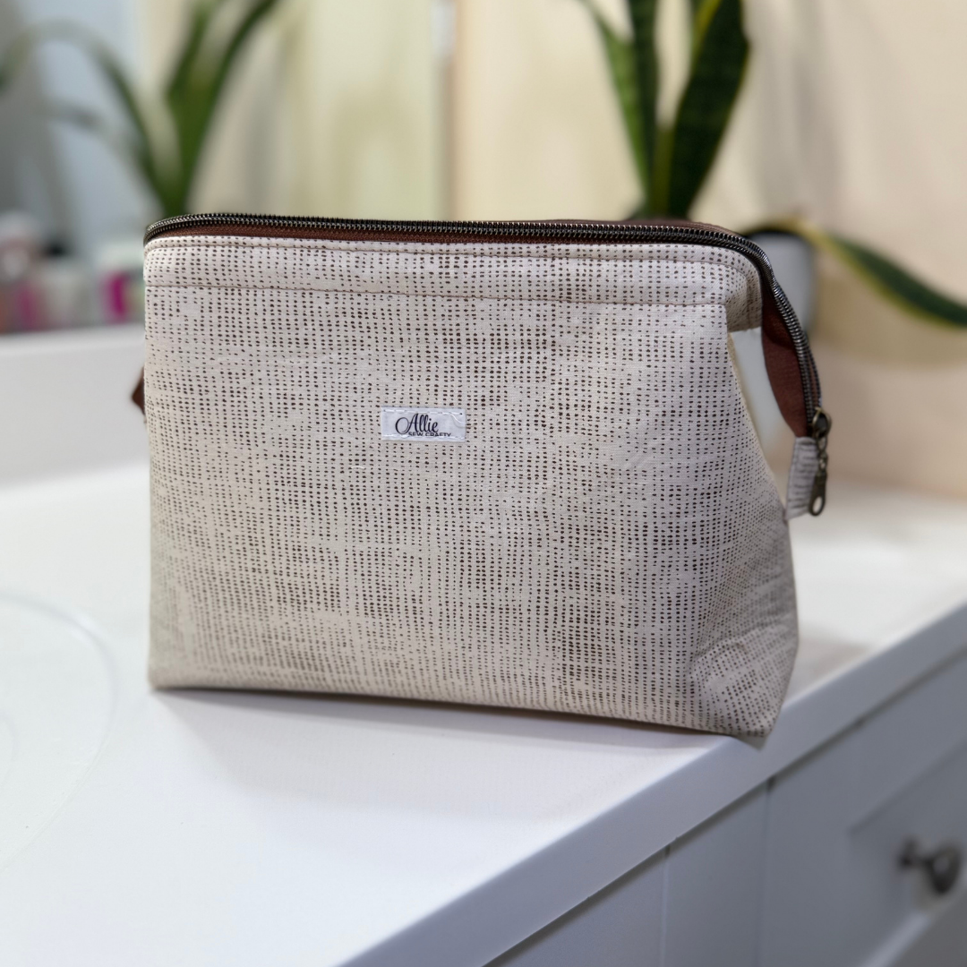 Textured pouch with a brand label on a white surface