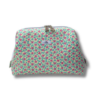 Floral patterned pouch with a visible brand logo on a white background