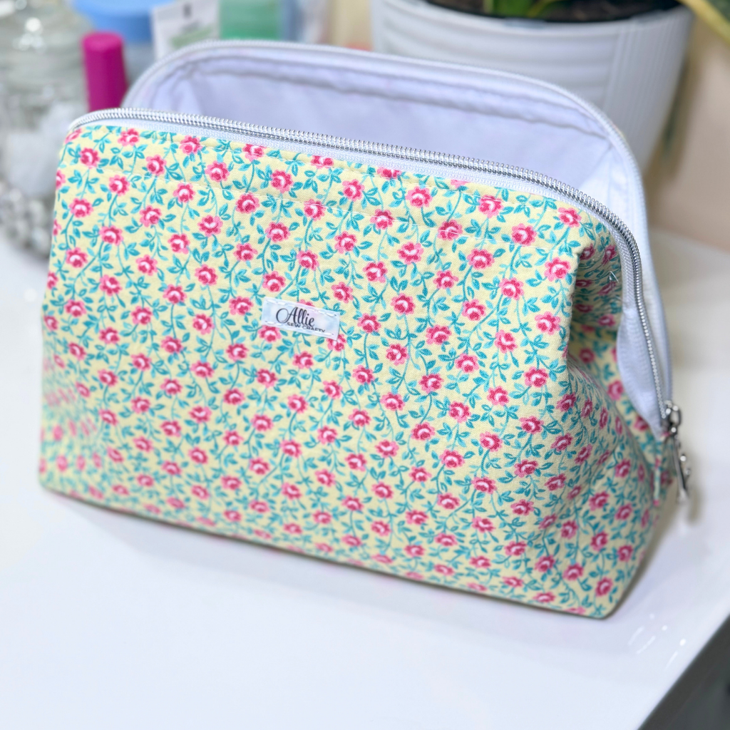 Floral-patterned pouch on a white surface with a blurred background