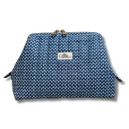 A blue and white patterned cosmetic pouch with a gold-tone metal clasp and a white brand label reading 'Allie The Beauty Box'.