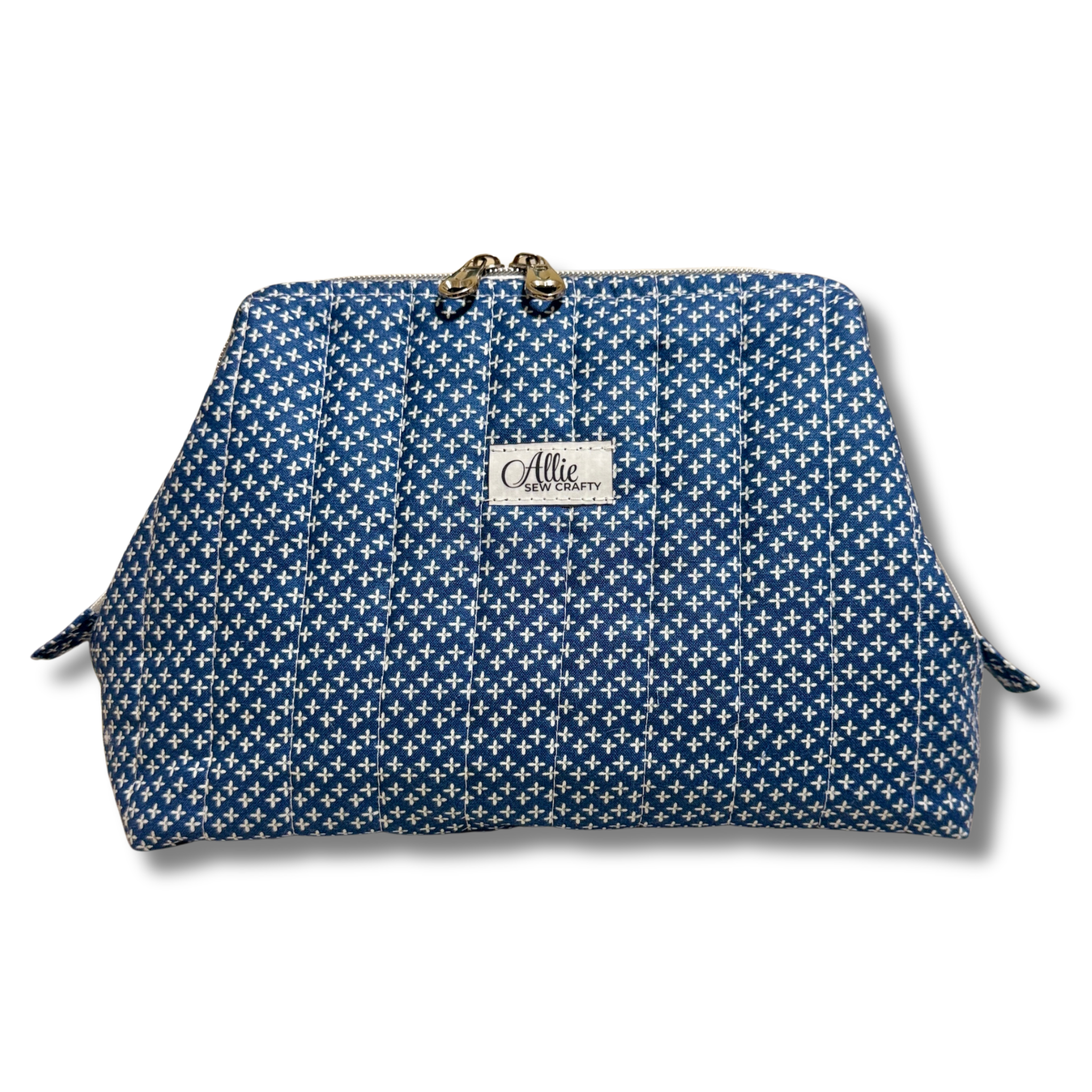 A blue and white patterned cosmetic pouch with a gold-tone metal clasp and a white brand label reading 'Allie The Beauty Box'.