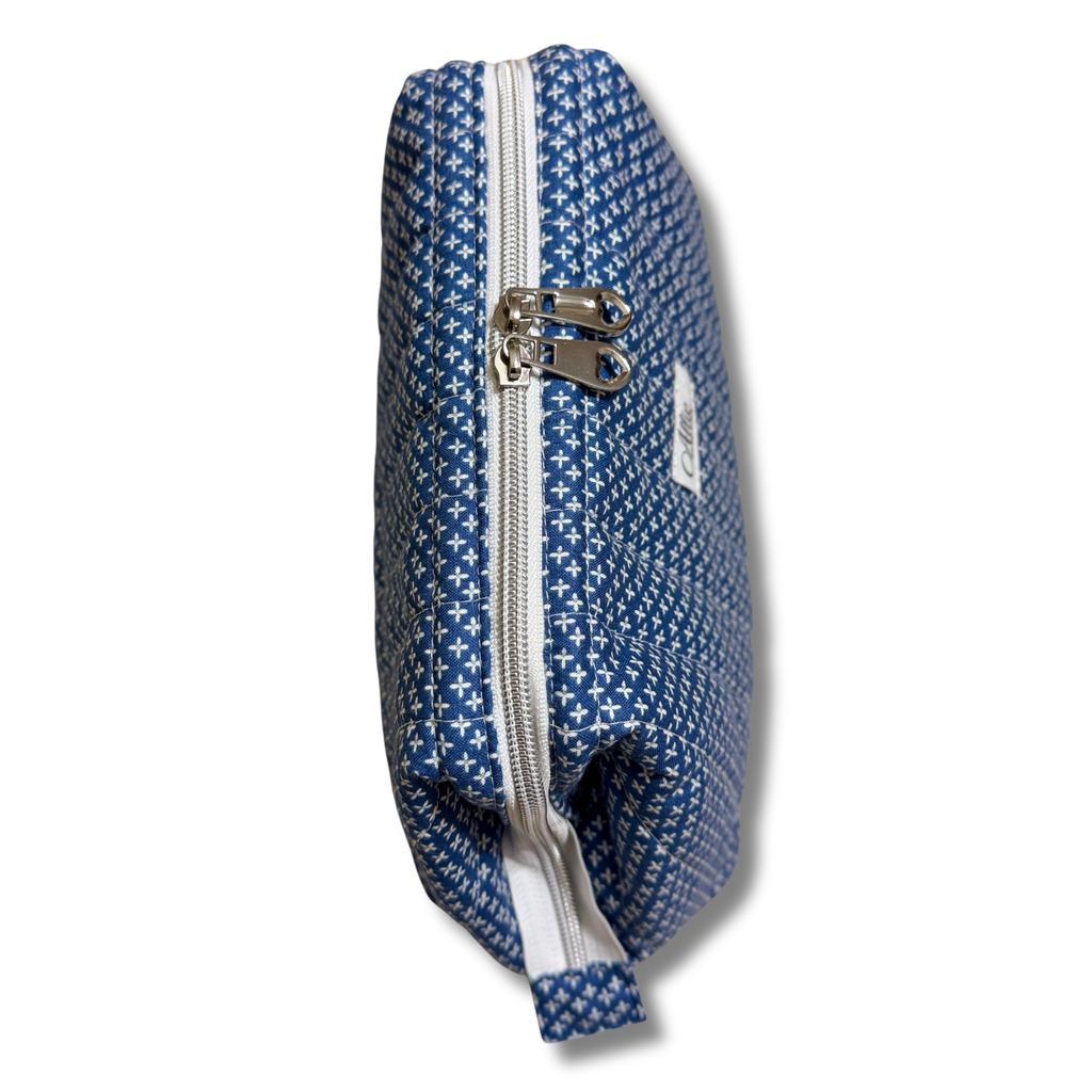 A blue and white patterned zippered pouch with silver metal hardware, shown on a plain white background.