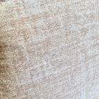 A close-up of a woven fabric texture in a heathered beige and light brown colorway.