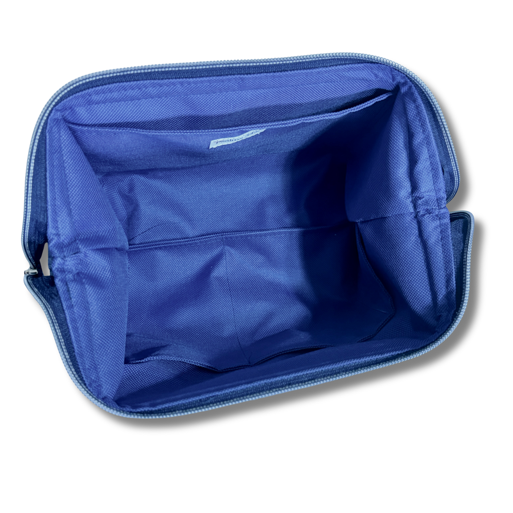 The interior of a blue zippered cosmetic bag or organizer pouch, showing fabric compartments and a zipper, isolated on a white background.
